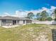 Spacious backyard featuring a patio, mature trees, and a white privacy fence at 3130 Clewiston St, Deltona, FL 32738