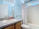 Bright bathroom featuring a white shower with a gray countertop sink at 3130 Clewiston St, Deltona, FL 32738