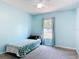 This bedroom features light blue walls and a cozy twin bed by a window at 3130 Clewiston St, Deltona, FL 32738