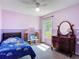 Bedroom features a decorative shelf, a window, and a double bed with blue covers at 3130 Clewiston St, Deltona, FL 32738