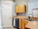 The kitchen features stainless steel appliances, light wood cabinets and a door to the left at 3130 Clewiston St, Deltona, FL 32738