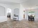 Open-concept living and dining area featuring wood-look tile flooring and a sliding glass door to the backyard at 3130 Clewiston St, Deltona, FL 32738