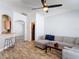 Comfortable living room with wood-look flooring, ceiling fan, and stylish sectional sofa with coffee table at 3130 Clewiston St, Deltona, FL 32738