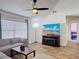 Living room features wood-look floors, a ceiling fan, and a television at 3130 Clewiston St, Deltona, FL 32738