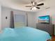 Comfortable main bedroom with a dresser and TV at 3130 Clewiston St, Deltona, FL 32738