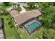 Stunning aerial view of home with screened pool, manicured lawn, and lush landscaping at 316 Cambridge Dr, Longwood, FL 32779