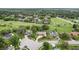 Extensive aerial view highlighting homes bordering a golf course amidst lush greenery at 316 Cambridge Dr, Longwood, FL 32779