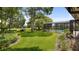 Serene backyard featuring a sparkling pool, screened enclosure, and lush landscaping at 316 Cambridge Dr, Longwood, FL 32779