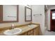 Bathroom with a double sink vanity and custom mirrors, complemented by tile flooring and abundant lighting at 316 Cambridge Dr, Longwood, FL 32779