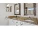 Bathroom with double sinks, granite countertops, framed mirrors, and new fixtures at 316 Cambridge Dr, Longwood, FL 32779