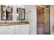 Bathroom with granite vanity, double sinks, and a tiled shower with a glass door at 316 Cambridge Dr, Longwood, FL 32779