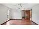 Bedroom featuring wood floors, a closet, and natural light from a large window at 316 Cambridge Dr, Longwood, FL 32779