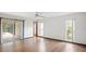 Bedroom with wood floors, a sliding glass door, and natural light from two windows at 316 Cambridge Dr, Longwood, FL 32779