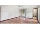 Bedroom with wood floors, sliding glass doors leading to the pool area and an ensuite bath at 316 Cambridge Dr, Longwood, FL 32779