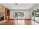 Cozy living room featuring stone fireplace, hardwood floors, built-in shelving and view of pool at 316 Cambridge Dr, Longwood, FL 32779