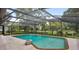 Backyard oasis featuring a large pool and screened enclosure with views of the landscaped surroundings at 316 Cambridge Dr, Longwood, FL 32779