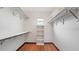 Spacious walk-in closet with wood-look floors, ample shelving, and a bright window for natural lighting at 316 Cambridge Dr, Longwood, FL 32779