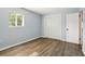 An empty bedroom with hardwood floors, a window, and a closet, ready for furnishings and personal touches at 320 Lakeview St # 220, Orlando, FL 32804