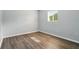 Bright bedroom with wood floors, window, and neutral walls at 320 Lakeview St # 220, Orlando, FL 32804