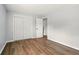 A clean bedroom with hardwood floors, a closet, and a doorway to a hallway, ready for personalization at 320 Lakeview St # 220, Orlando, FL 32804
