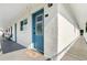 Exterior hallway with blue doors, textured walls, and a sliver of a view at 320 Lakeview St # 220, Orlando, FL 32804