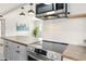 Modern kitchen with stainless steel appliances, wood countertops, a range hood, and ample counter space at 320 Lakeview St # 220, Orlando, FL 32804