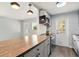 Bright kitchen with stainless steel appliances, wood countertops, updated lighting, and access to an outdoor area at 320 Lakeview St # 220, Orlando, FL 32804