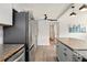 An open-concept kitchen with stainless steel appliances, wooden countertops, and a view into the adjacent hallway at 320 Lakeview St # 220, Orlando, FL 32804