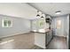 Inviting living space featuring an open kitchen with a gray island, wood floors, and windows at 320 Lakeview St # 220, Orlando, FL 32804