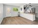 Cozy living space with an open kitchen, wood laminate flooring, and a white door at 320 Lakeview St # 220, Orlando, FL 32804