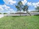Spacious backyard featuring a lush lawn and a white fence, offering privacy and room for outdoor activities at 331 Erie Ct, Kissimmee, FL 34759