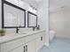 Bathroom features double sink vanity, decorative tile floors, and a standalone soaking tub at 331 Erie Ct, Kissimmee, FL 34759