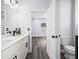Bathroom with dual sinks, sleek vanities, and a view into the well-lit bedroom space at 331 Erie Ct, Kissimmee, FL 34759