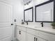 Bathroom features double sink vanity, stone countertop, black fixtures, and decorative tile floors at 331 Erie Ct, Kissimmee, FL 34759