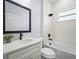 Bathroom with a modern tub and shower featuring a black shower head, along with a sleek sink and countertop at 331 Erie Ct, Kissimmee, FL 34759
