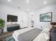 Modern bedroom with stylish decor, featuring a sleek TV, artwork, and a cozy rug for a contemporary aesthetic at 331 Erie Ct, Kissimmee, FL 34759
