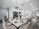 Open-concept dining area flows into a modern kitchen with white cabinets and a large island for entertaining at 331 Erie Ct, Kissimmee, FL 34759