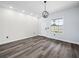 Inviting entryway features luxury vinyl plank flooring, decorative accent wall, modern light fixture and natural light at 331 Erie Ct, Kissimmee, FL 34759