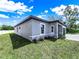 Home exterior featuring well-maintained landscaping, decorative stone accents, and neutral-colored stucco at 331 Erie Ct, Kissimmee, FL 34759