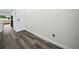 Hallway with luxury vinyl plank flooring and decorative wall, leading to kitchen and other rooms in the house at 331 Erie Ct, Kissimmee, FL 34759