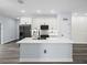 Bright kitchen features white cabinets, stone countertops, stainless steel fridge, and large kitchen island at 331 Erie Ct, Kissimmee, FL 34759