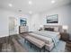 Spacious main bedroom featuring a neutral color scheme, a queen bed, and a sitting bench at 331 Erie Ct, Kissimmee, FL 34759