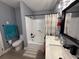 Bathroom featuring a modern vanity, black hardware, shower-tub combo and neutral color palette at 3391 S Kirkman Rd # 1236, Orlando, FL 32811