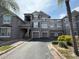 Attractive gray building exterior featuring multiple units and garage parking at 3391 S Kirkman Rd # 1236, Orlando, FL 32811
