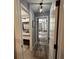 Hallway with a view to the primary bedroom and bathroom with modern decor and gray flooring at 3391 S Kirkman Rd # 1236, Orlando, FL 32811