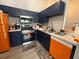 Bright kitchen featuring stainless steel appliances, navy cabinets, and marble countertops at 3391 S Kirkman Rd # 1236, Orlando, FL 32811