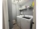 Modern laundry room featuring a new washer and dryer with a wire rack for storage at 3391 S Kirkman Rd # 1236, Orlando, FL 32811