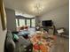 Open-concept living space with dining room, a gray sofa, colorful rug and contemporary lighting at 3391 S Kirkman Rd # 1236, Orlando, FL 32811