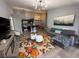 Open-concept living area boasts a comfortable gray couch, a vibrant floral rug, and modern lighting fixtures at 3391 S Kirkman Rd # 1236, Orlando, FL 32811