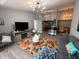 Bright living room featuring stylish decor, a modern chandelier, and an open floor plan flowing into the kitchen at 3391 S Kirkman Rd # 1236, Orlando, FL 32811